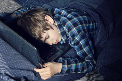 A kid sleeping on a notebook